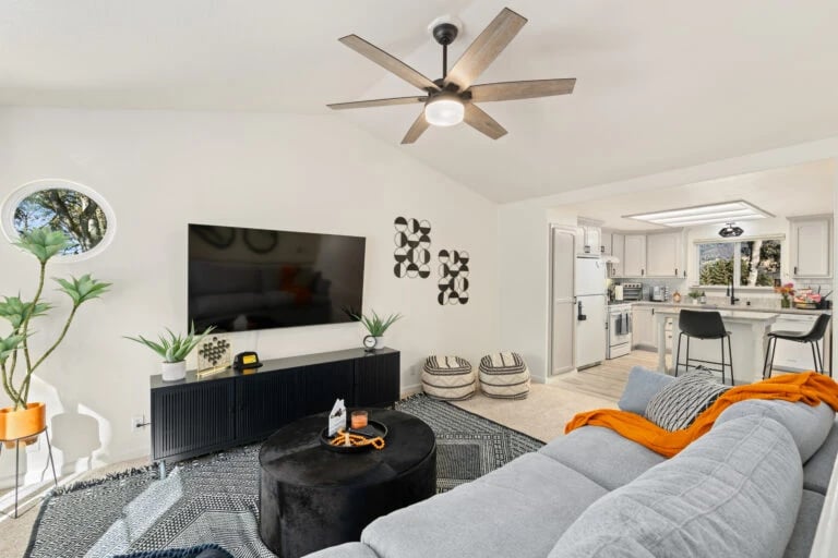 Modern living room with gray sectional sofa and flat-screen TV